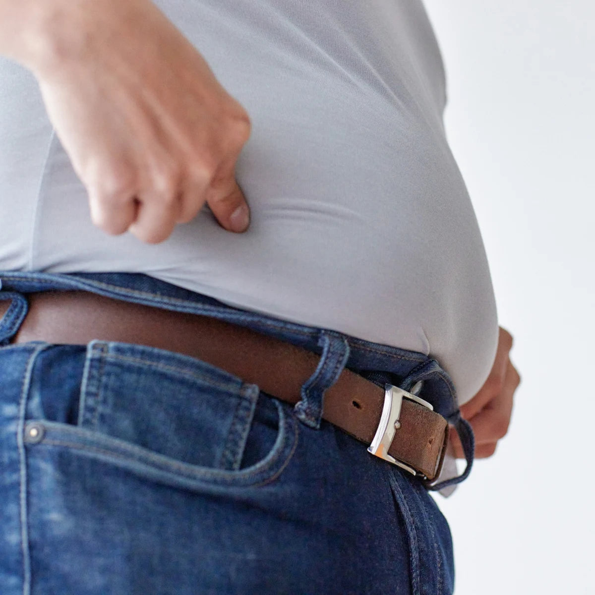 Traditional belt buckle pressing against the waist