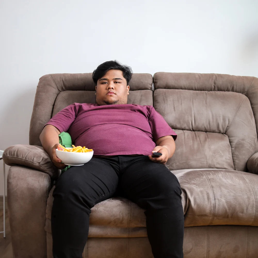 Plus-size person relaxing while seated at home
